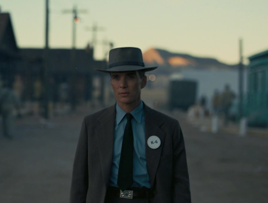 Scene of J. Robert Oppenheimer, portrayed by actor Cillian Murphy, walking the streets of Los Alamos. Still from the motion picture. Oppenheimer. Directed by Christopher Nolan, performances by Cillian Murphy, Emily Blunt, Robert Downey Jr., Syncopy, Atlas Entertainment, Universal Studios, 2023.